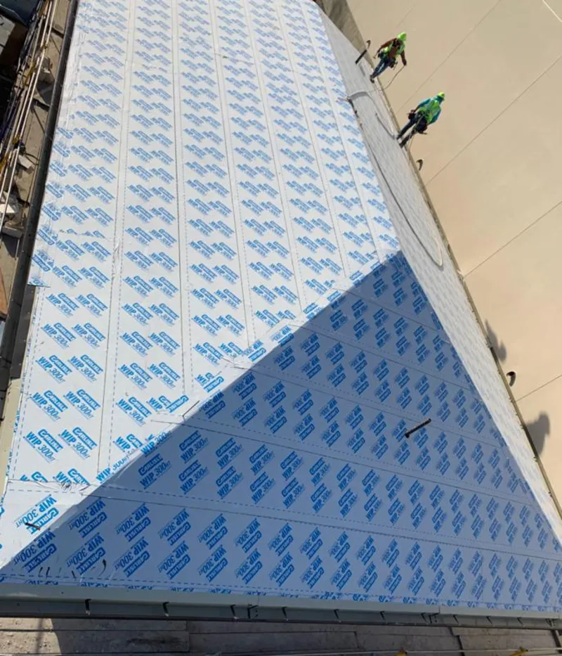 Professional roofers installing underlayment on a metal roof in Ontario